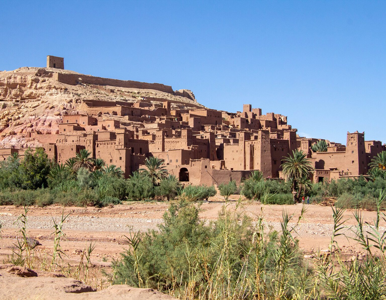 Ancient earthen buildings under a clear blue sky.