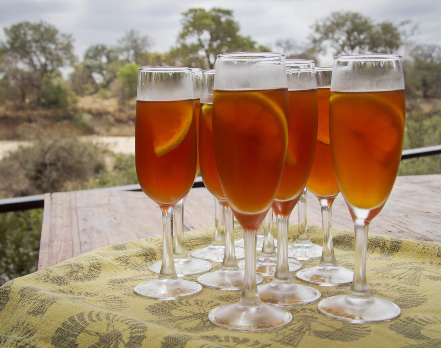 Glasses filled with iced tea on a table outdoors.