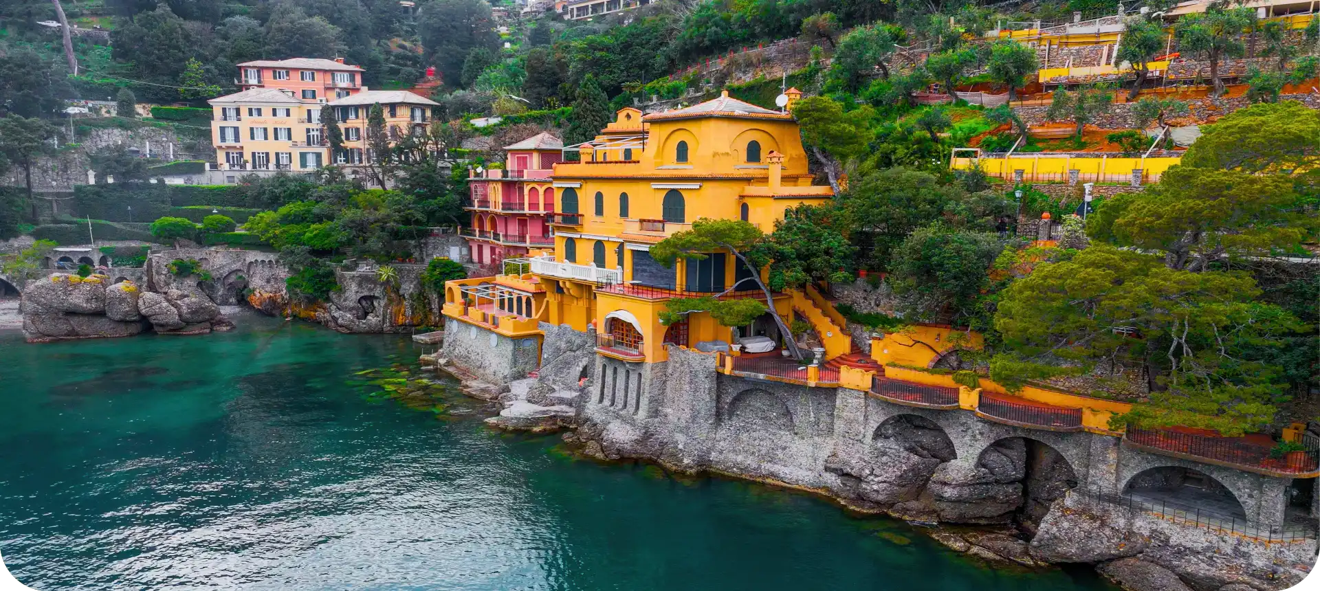 Colorful houses built on rocky cliffs by the sea.