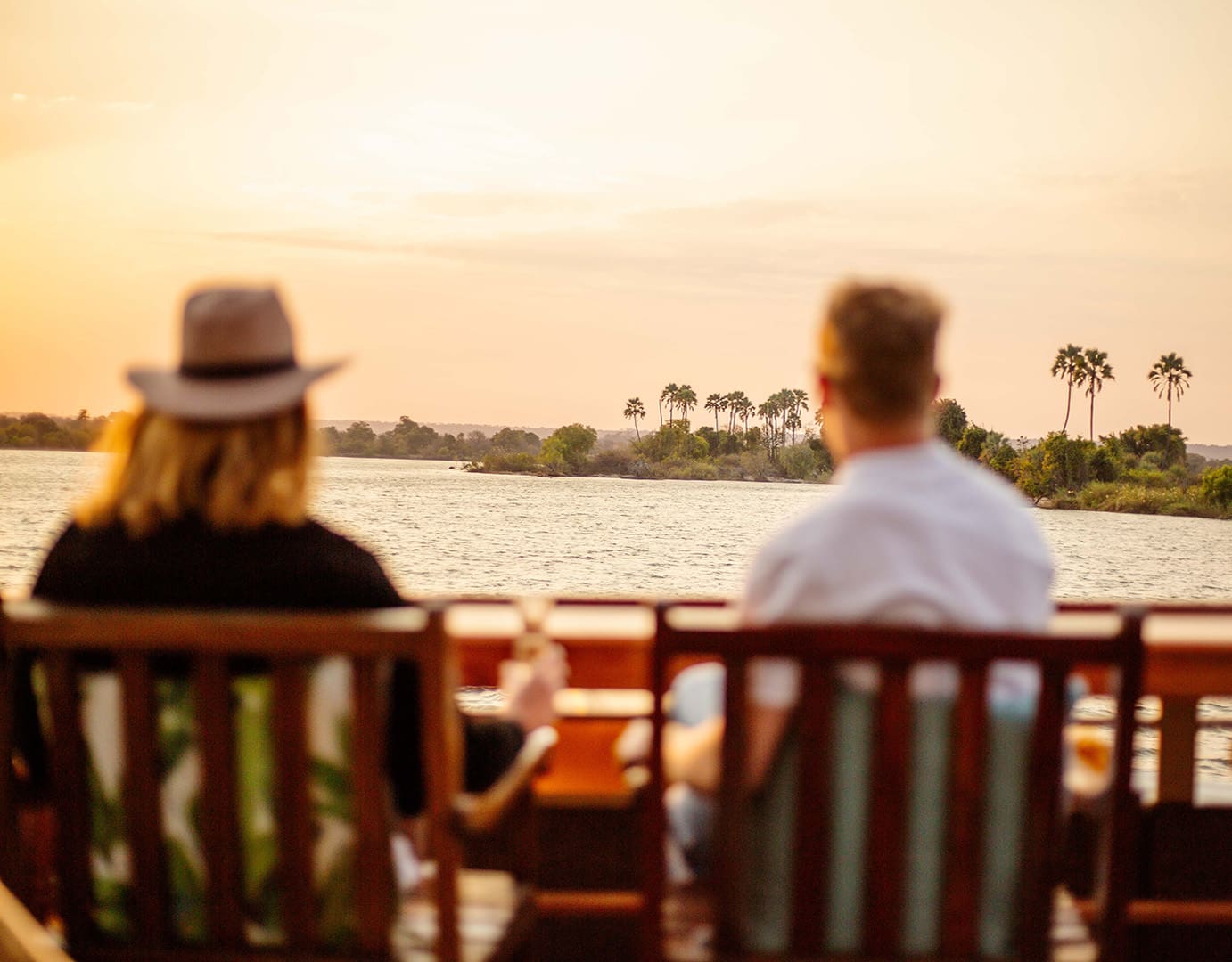 Couple enjoying sunset view by the water.