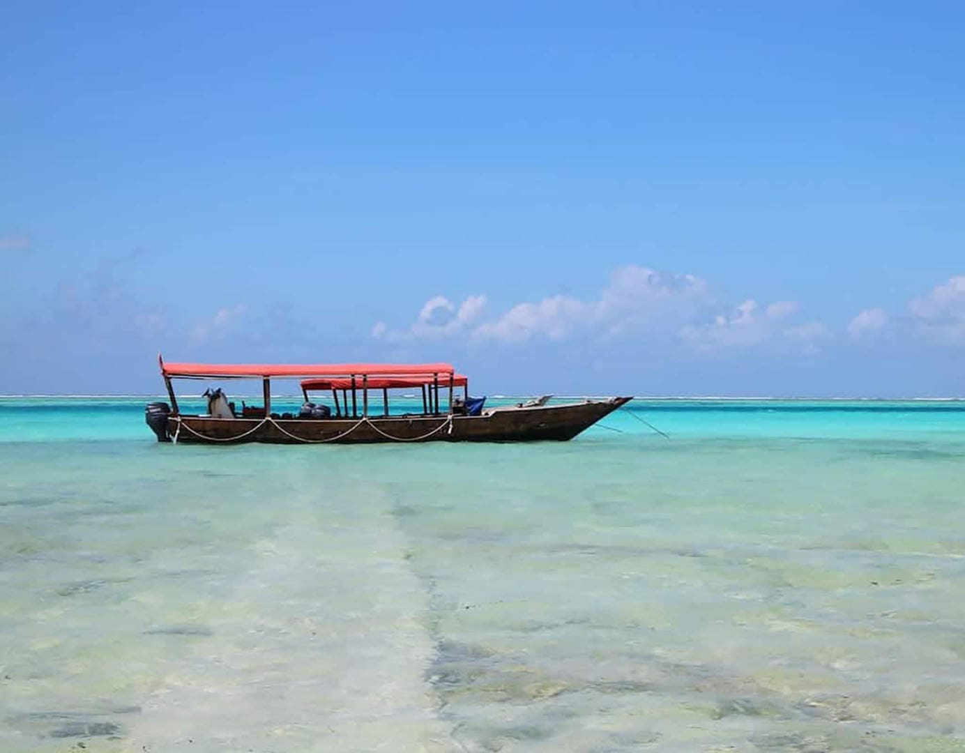 Boat anchored in clear turquoise waters.